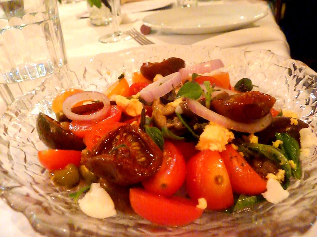 P1200772.JPG Tomato Salad, the salad the the whole town tries to imitate (42 NIS). Red, black and dried cherry tomatoes, crushed tomatoes, white cheese and boiled yolks, red onions. A good salad but I wouldn't exaggerate with the definitions written in the menu.
