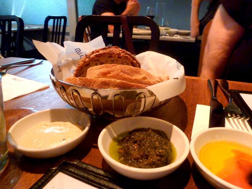 P1200848.JPG Bread basket (14 NIS), we received two types of fresh bread, white and dark, only 2-3 slices of each with three condiments: olive oil-tomato-balsamic vinegar; za'atar pesto, eggplant cream. All three were excellent. The eggplant cream was smokey but smooth, the pesto very cool as well.