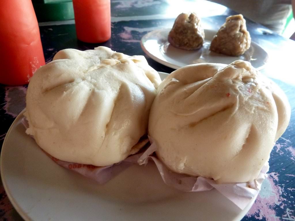 Chinese steamed Bao buns stuffed with chicken or pork with spicy hot sauce