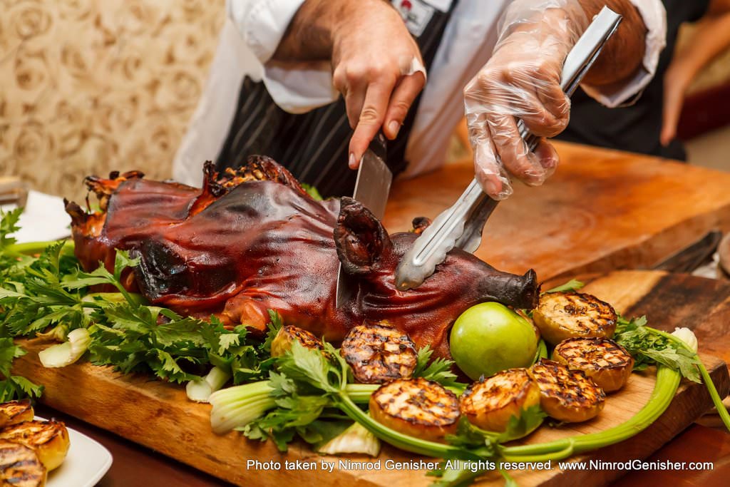 Whole piglet marinated in Calvados, honey and apples.