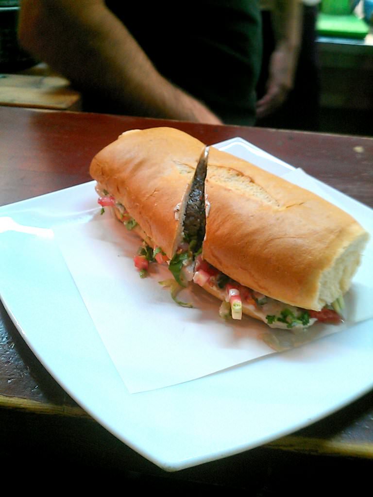Freshly made beef and lamb kebabs with lemon squeezed on top - Shmulik's Kebaba.