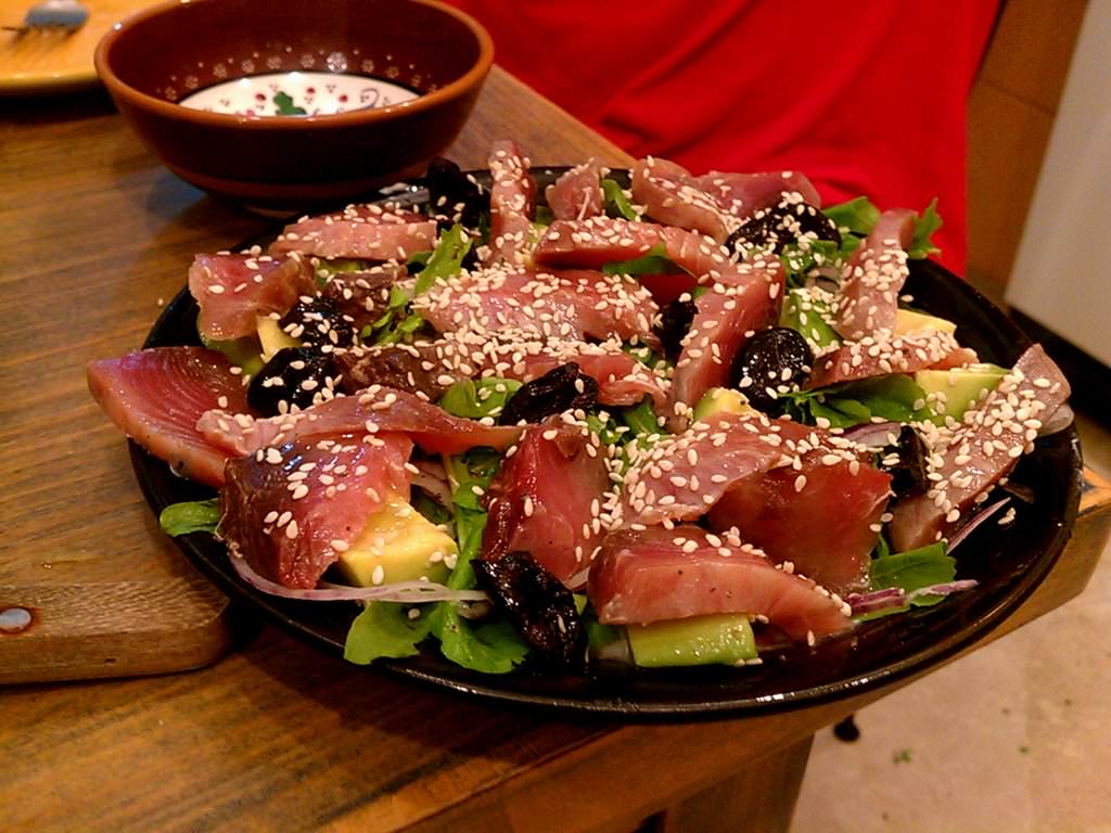 Sashimi salad: yogurt, rocket, red onions, avocado, black olives and sesame with fresh bonito.