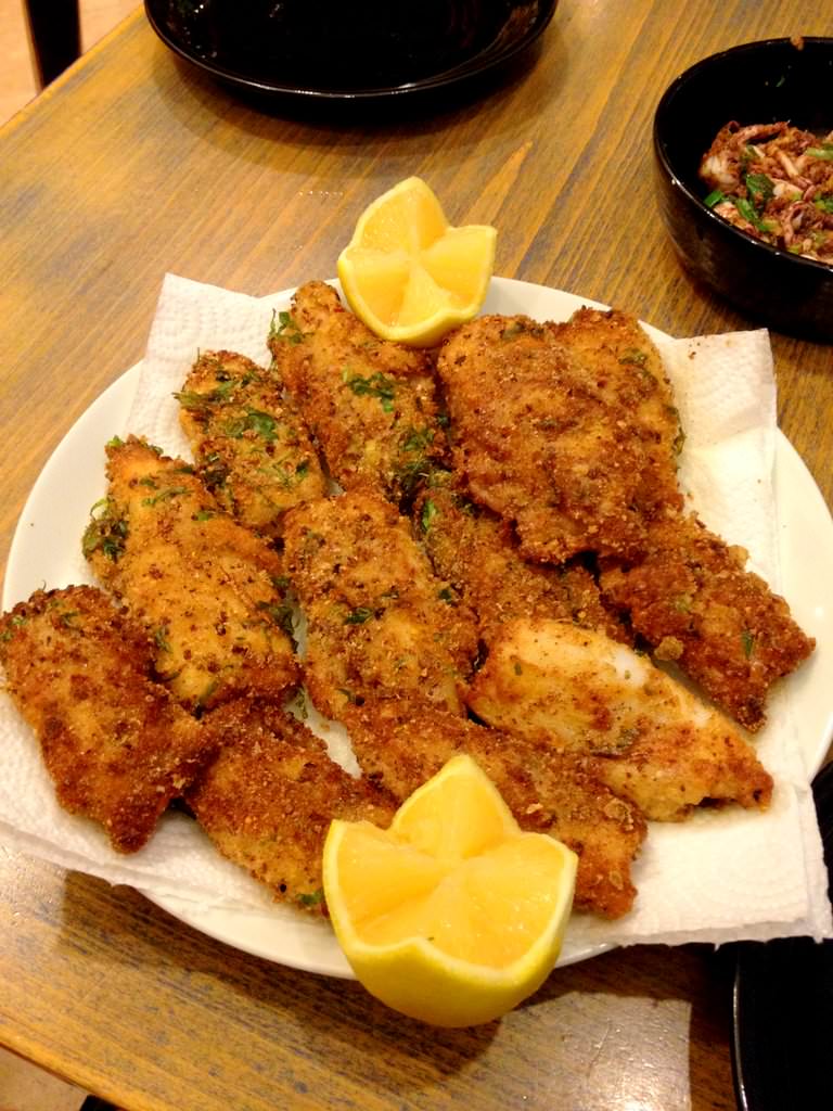 Calamari steaks Milanese (Shnitzel) with home made bread crumbs, garlic and basil. Don't forget to press lemon juice on top.