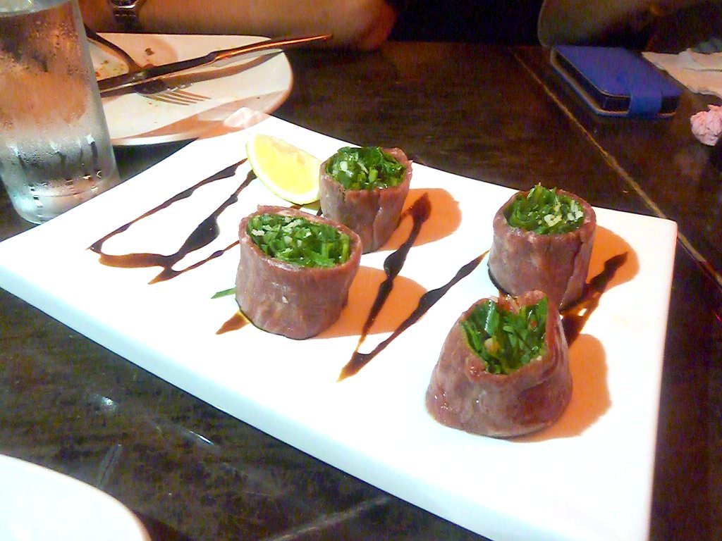 Carpaccio flowers: Filet of beef, arugula, baby greens and parmesan on balsamic vinegar. One of NG's flag dishes.