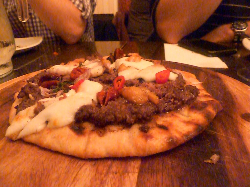 NG's "Pizza", Flatbread with grilled Entrecote chopped on top, Solog cheese, tomatoes, raisins, shallots, garlic confit, oregano and some fresh chilli.