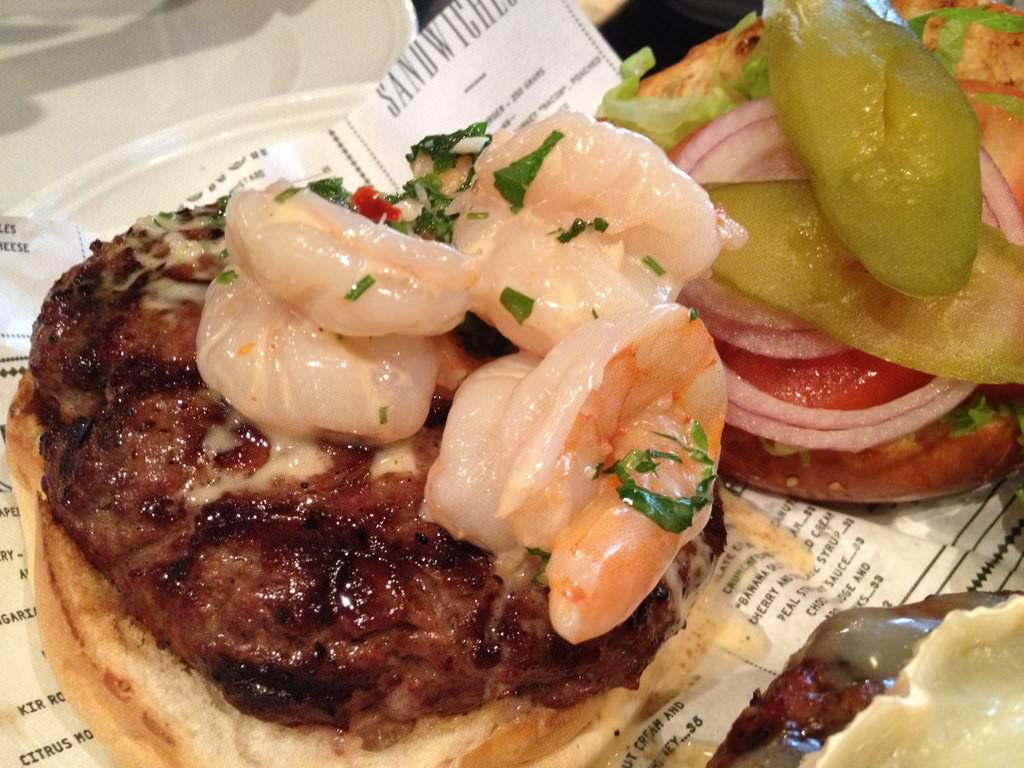 Shrimp burger (65 NIS). Isn't a burger made from shrimp only (bummer), but a burger with a small dish of shrimp tossed in white wine, garlic and a touch of cream on top. The sauce is really good and adds a lot to the flavor but leaks from the burger.