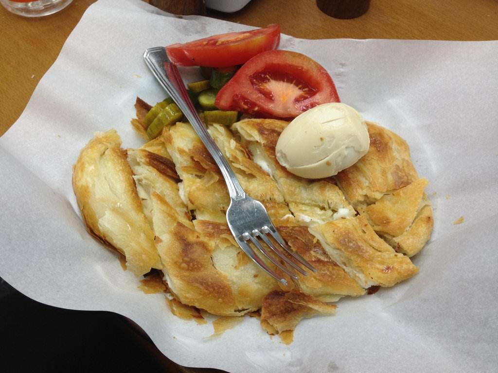 The "Complete Burekas Dish" (25 ILS) served with thick slices of ripe delicious tomatoes, great home-made pickles and a boiled egg - Original Turkish Burekas