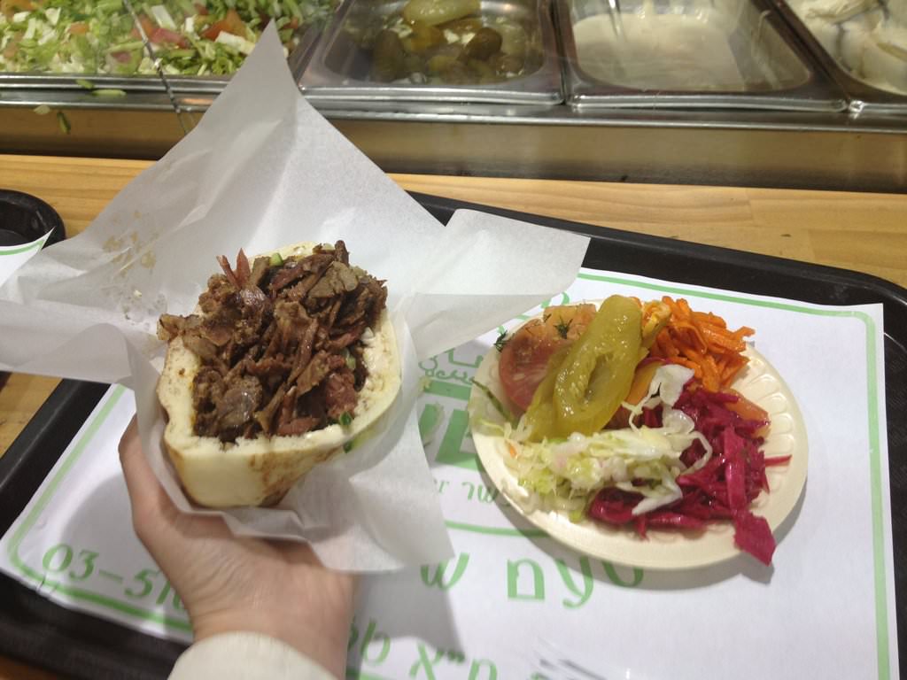 Half a dish of shwarma in fresh made pita with salads (20 ILS).