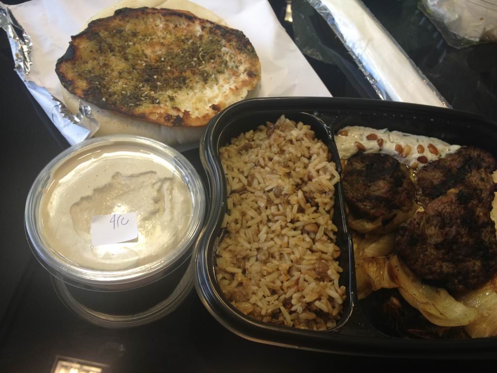 3 lamb kebabs sitting on top of warm tahini with pine nuts and grilled onions, a side dish of Majadra and some good portion of great hummus (37 ILS) came with pita and Za'atar pita.