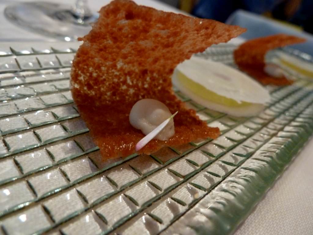 Two part amuse bouche: Caramelized Brioche with foie gras; Almond "sandwich" with green apple and a purple peanut center.