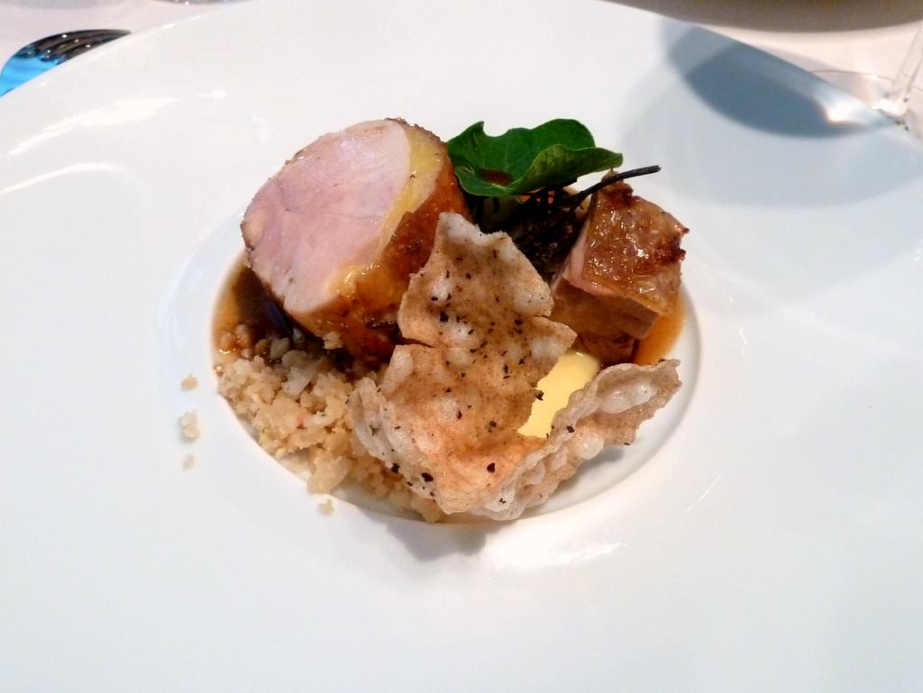 Hay smoked breast and thigh of "Poularde de Bresse" with Jerusalem Artichoke, Parmesan and walnuts "sand", Parmesan cheese and black truffles sauce, crispy tapioca, a Capucine leaf and Za'atar.